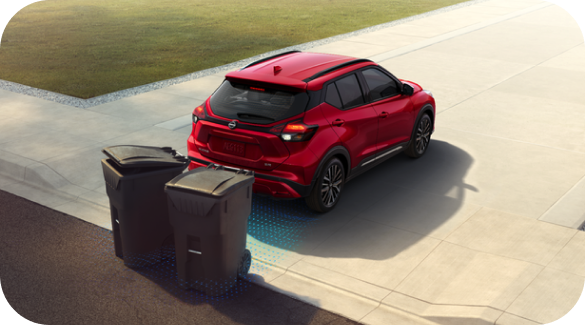 Nissan KICKS showing car backing up and avoiding trash cans with intelligent emergency braking