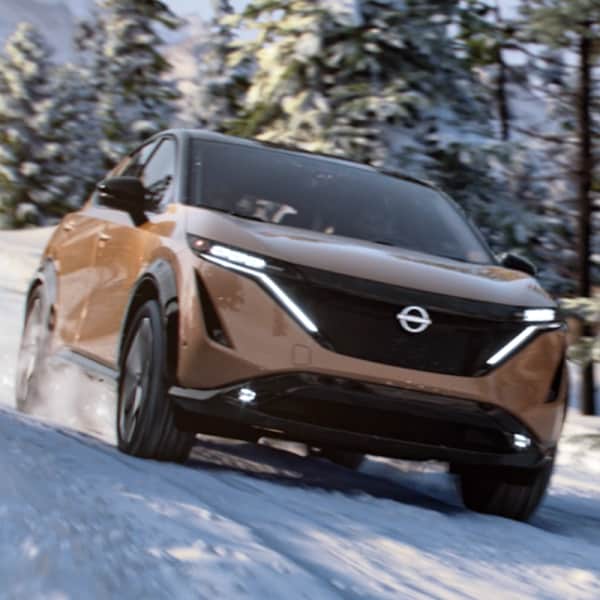 Nissan ARIYA driving through snow