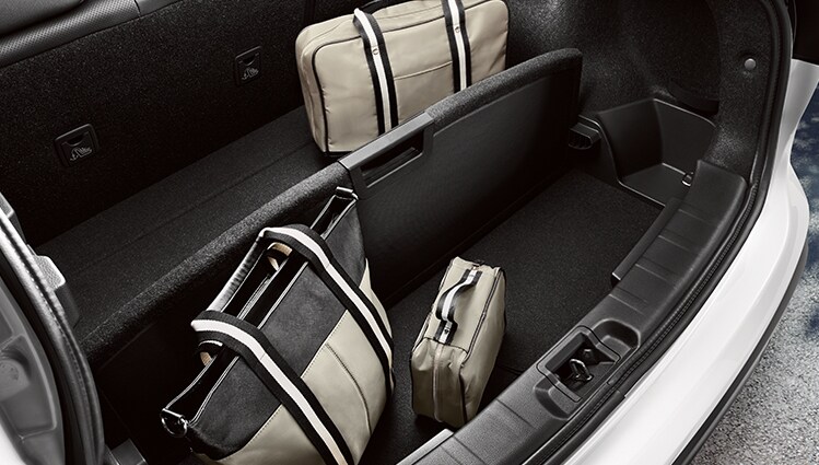 Pieces of luggage divided in the rear cargo area of the 2022 Nissan Qashqai