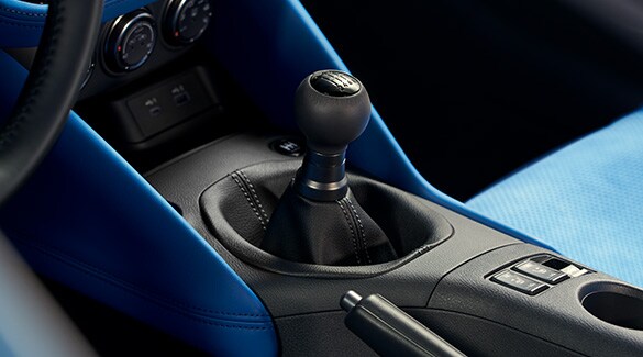 2023 Nissan Z blue interior showing manual transmission gear shifter.