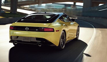 2023 Nissan Z in yellow driving on a highway to illustrate performance.