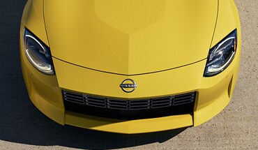 2023 Nissan Z in yellow showing hood to illustrate aluminum body panels.
