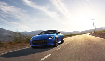2023 Nissan Z in blue on a rural road.