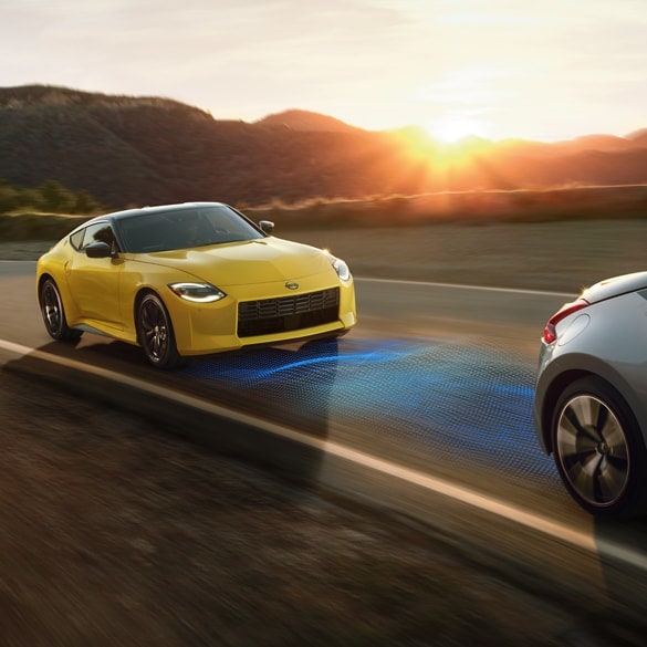 Yellow 2024 Nissan Z approaching another vehicle from behind. The space between the vehicles is lit up blue to demonstrate Intelligent Cruise Control