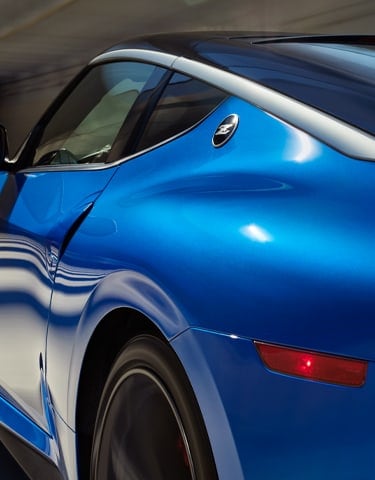 Angled side view of a blue 2024 Nissan Z showing the katana inspired roof