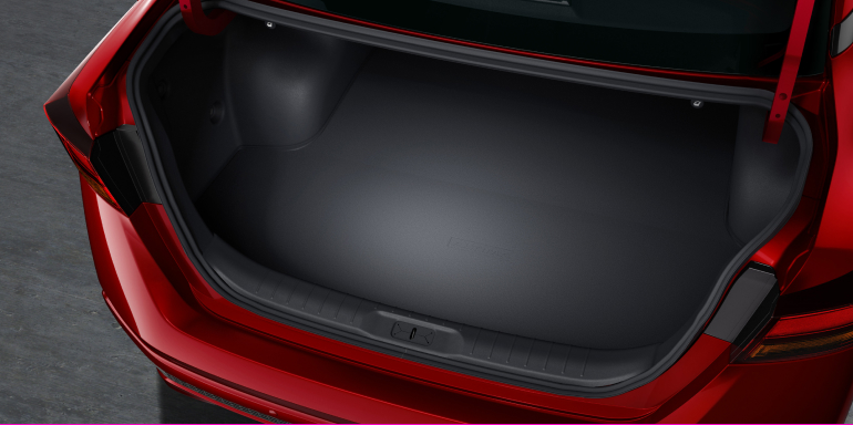 Open trunk of red 2024 Nissan Altima showing cargo storage