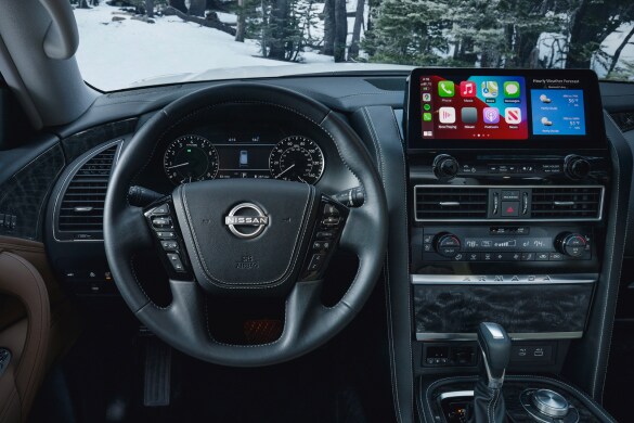 2023 Nissan Armada drivers view showing widescreen display, gauges, and steering wheel.