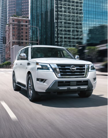 White 2024 Nissan Armada driving on a city street