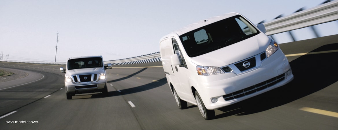 Two Nissan commercial vans driving together
