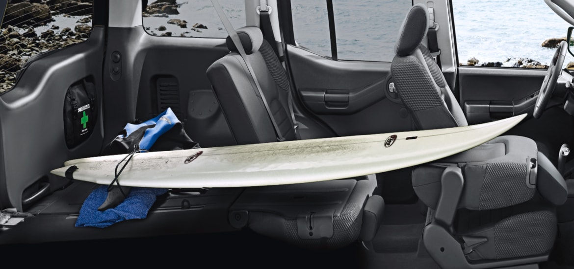 Surfboard fit into Nissan Xterra interior with seats folded down