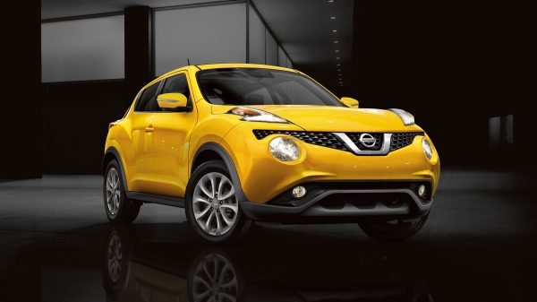 A front passenger side view of a yellow Nissan JUKE parked on an angle