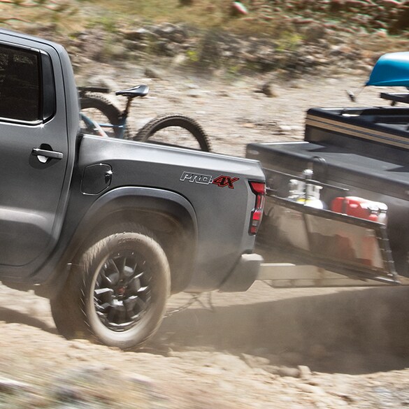 2022 Nissan Frontier rear tire going over rocks illustrating electronic locking rear differential.