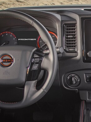 2023 Nissan Frontier drivers-view of steering wheel and cockpit gauges