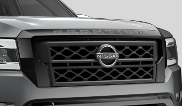2023 Nissan Frontier Front grille with exclusive black exterior accents.