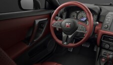 2023 Nissan GT-R interior view of driver's seat, steering wheel and instrument panel.