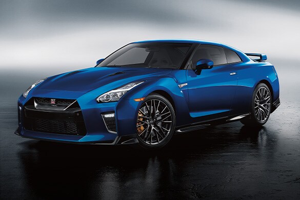 2023 Nissan GT-R in Bayside Blue on a gray background.