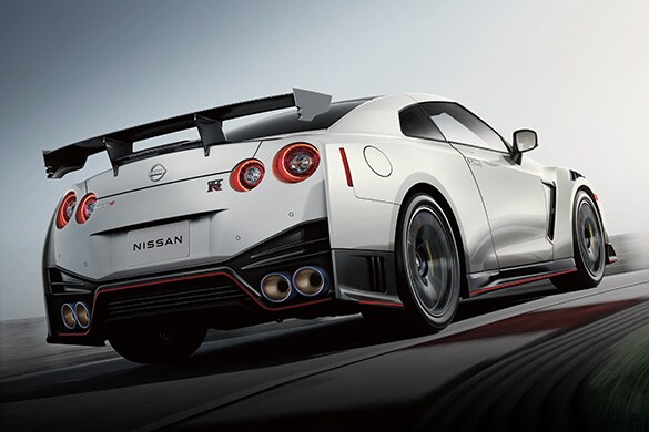 2023 Nissan GT-R driving on a racetrack, rear view.