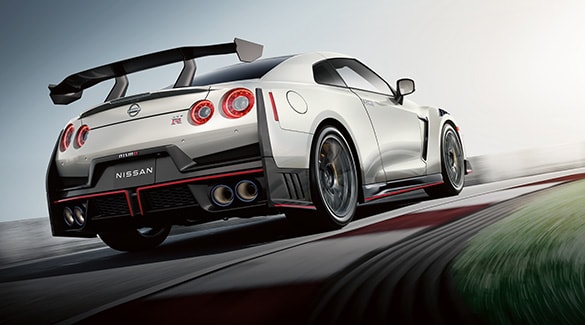 2024 Nissan GT-R with spoiler driving on a racetrack.