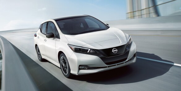 2023 Nissan LEAF in white on an overpass demonstrating aerodynamic design