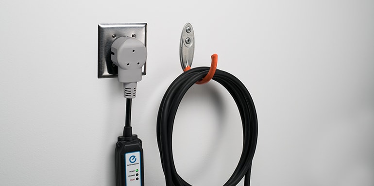 2025 Nissan LEAF plugged to a standard outlet for charging