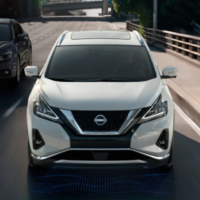 Front view of a white 2024 Nissan Murano driving