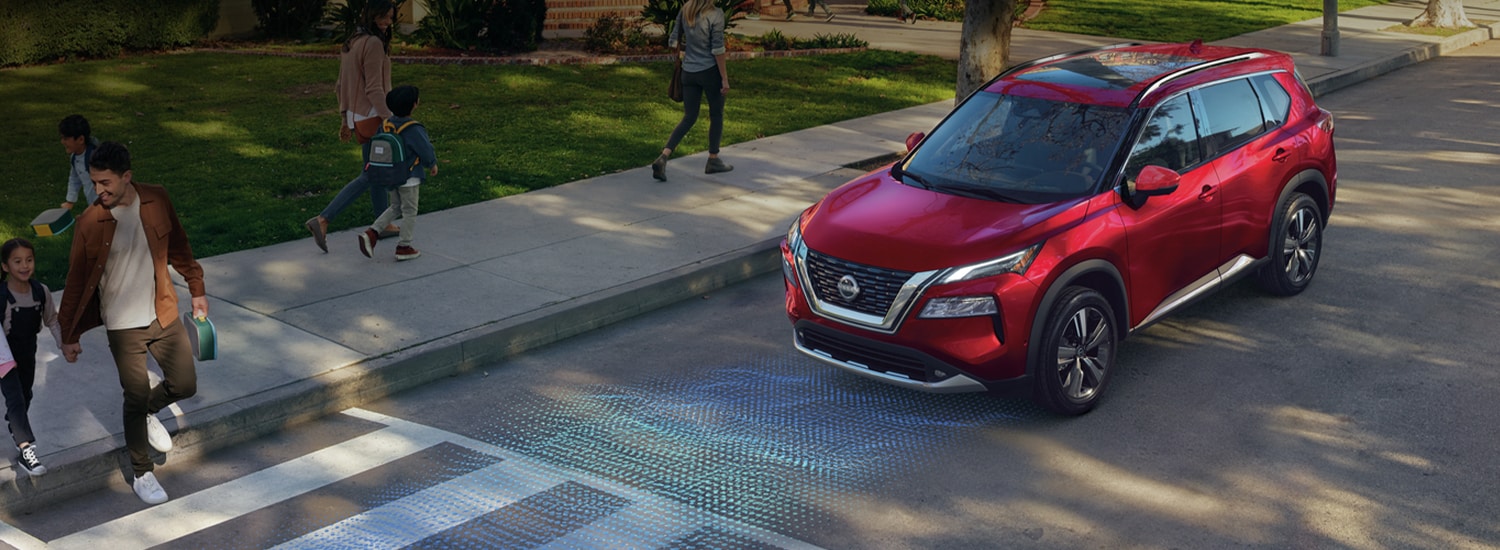 2023 Nissan Rogue stopped at a crosswalk illustrating safety shield 360 sensors.