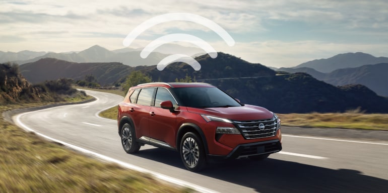 2024 Nissan Rogue driving on road showcasing WIFi connectivity feature