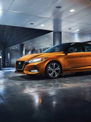 2022 Nissan Sentra in Two-tone Monarch Orange Metallic / Super Black at night near building