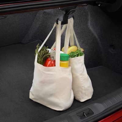 Close up view of 2024 Nissan Versa Trunk space with grocery hooks