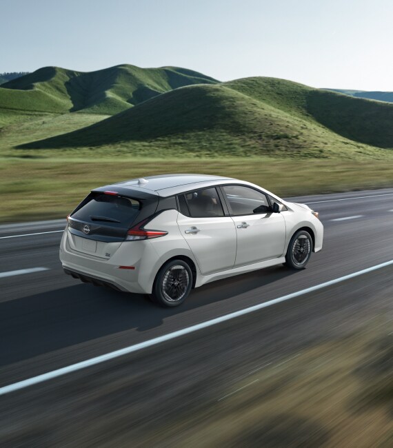 2023 Nissan LEAF electric car driving in front of hills