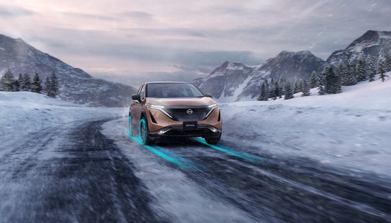 Nissan ARIYA driving across snowy terrain  demonstrating EV capability