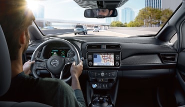 Interior view of man driving Nissan LEAF