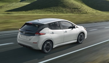 Nissan LEAF driving past field