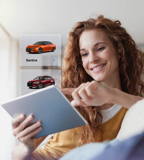 A woman browsing local Nissan inventory on her tablet