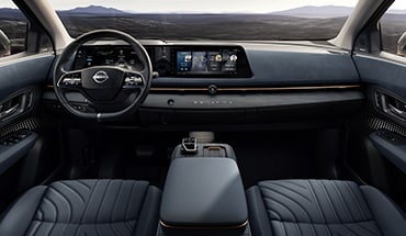 2023 Nissan Ariya interior view of front seats, centre console and dashboard.